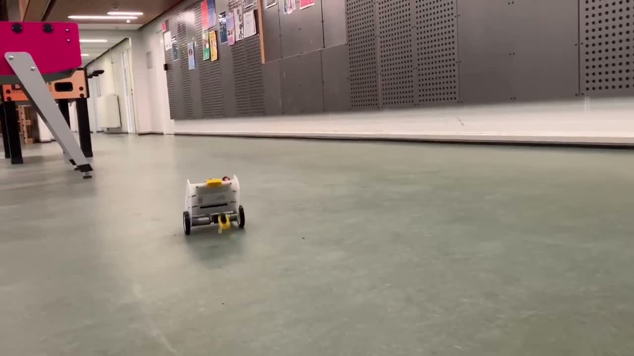 Two-wheeled self-balancing REGBOT robot driving upright along a corridor